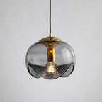 Product shot of this Clérachic pendant's smoky grey glass shade and gold frame, lit against a plain grey backdrop.
