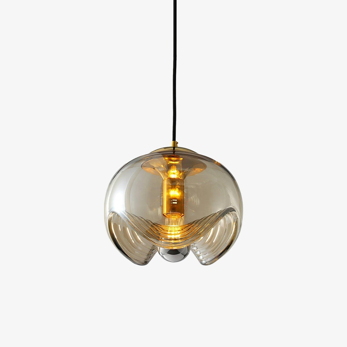 Close view of this Clérachic pendant's ribbed amber glass shade and gold fitter, set against a plain white background.
