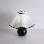 Wavecrest table lamp shade glowing in a styled bedroom