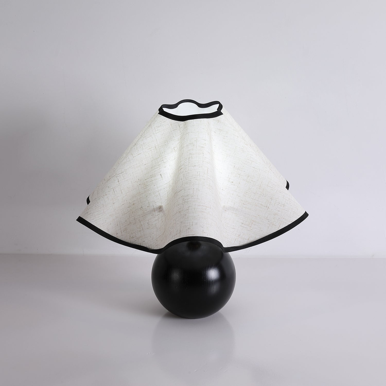 Wavecrest table lamp shade glowing in a styled bedroom