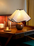 Wavecrest table lamp with shade glowing softly from within