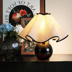 Wavecrest table lamp front-on view with draped linen shade