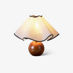 Wavecrest table lamp showing the sculptural curve of the linen shade