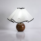Wavecrest table lamp glowing beside a chair in a quiet corner