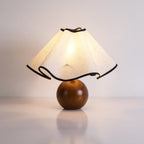 Wavecrest table lamp with wave-draped linen shade glowing softly on a side table