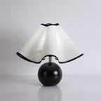 Wavecrest table lamp lit warmly on a wooden console