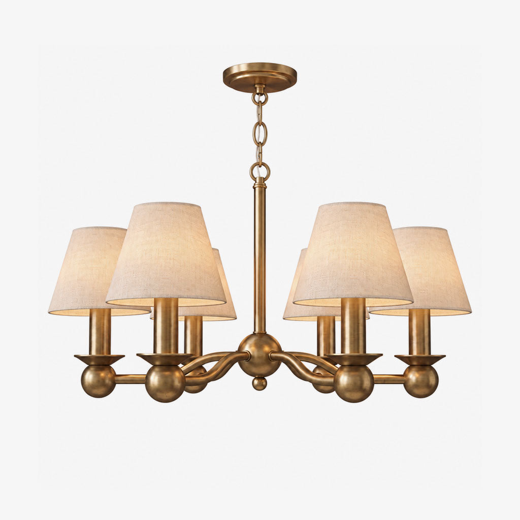 A brushed brass Clérachic chandelier with six fabric drum shades, photographed unlit on a plain white background.