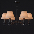 In matte black, this six-light Clérachic chandelier hangs unlit with fabric drum shades on arched branching arms.