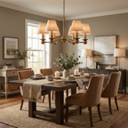 This brushed brass Clérachic chandelier glows above a dark wood dining table styled with a console and framed art.