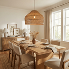 This Clérachic pendant hangs above a wood dining table set with woven placemats, a sideboard of framed prints behind.