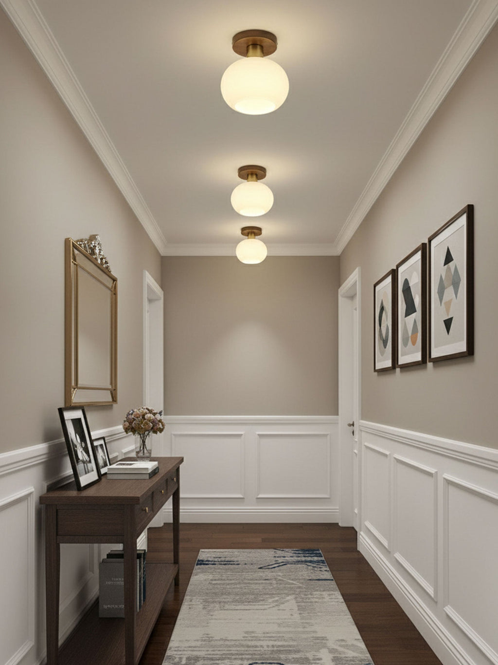 A console table and mirror sit beneath three of these Clérachic ceiling lights in a warmly lit hallway.