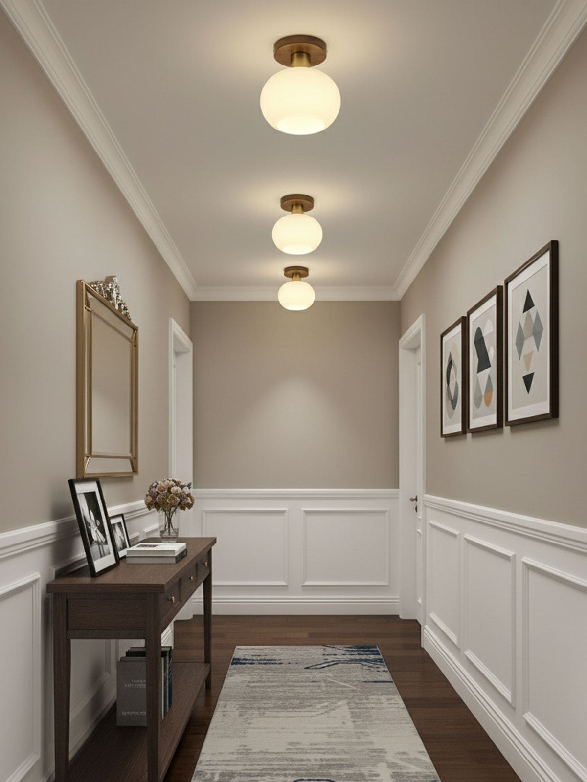A console table and mirror sit beneath three of these Clérachic ceiling lights in a warmly lit hallway.