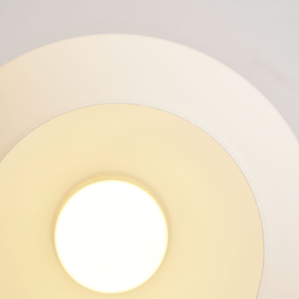 Close view of the lit opal glass globe on this Clérachic ceiling light, its warm glow spreading across the ceiling.