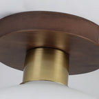 Seen from below, the walnut canopy and copper sleeve of this Clérachic ceiling light fill the frame.