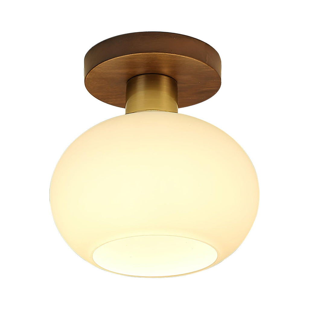 Glowing softly from within its opal glass shade, this Clérachic ceiling light sits on a plain background.