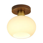 Glowing softly from within its opal glass shade, this Clérachic ceiling light sits on a plain background.