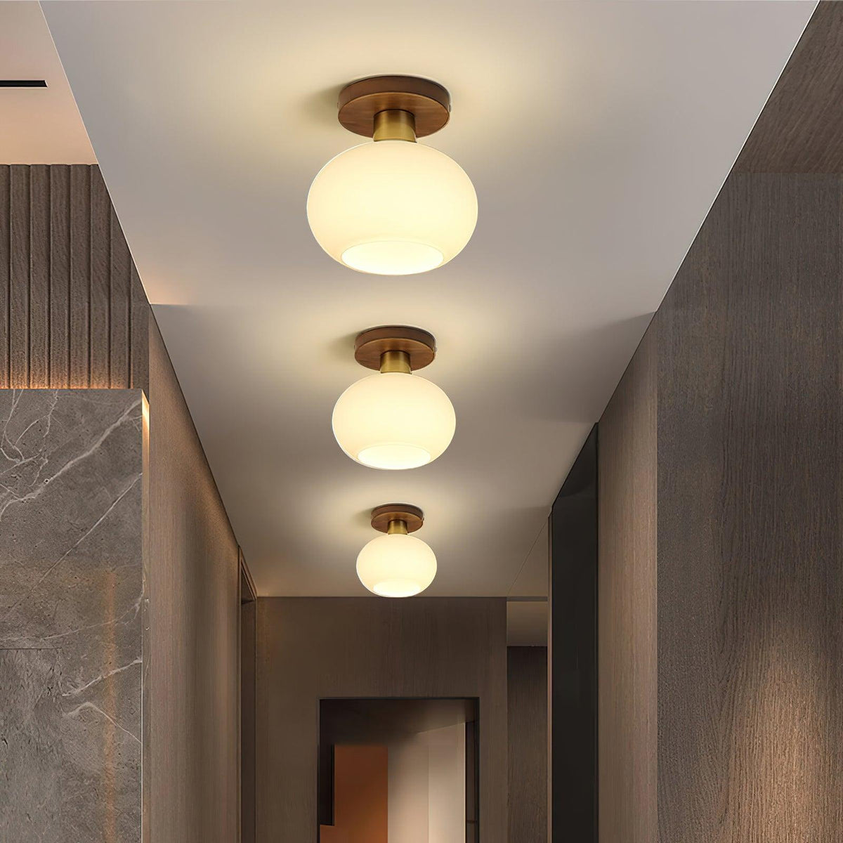 Three of these Clérachic ceiling lights glow warm above a hallway lined with dark stone and wood panels.