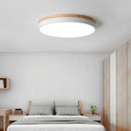 White round ceiling light casting even light in a hall