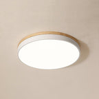 White ceiling light with warm wood rim in a bedroom