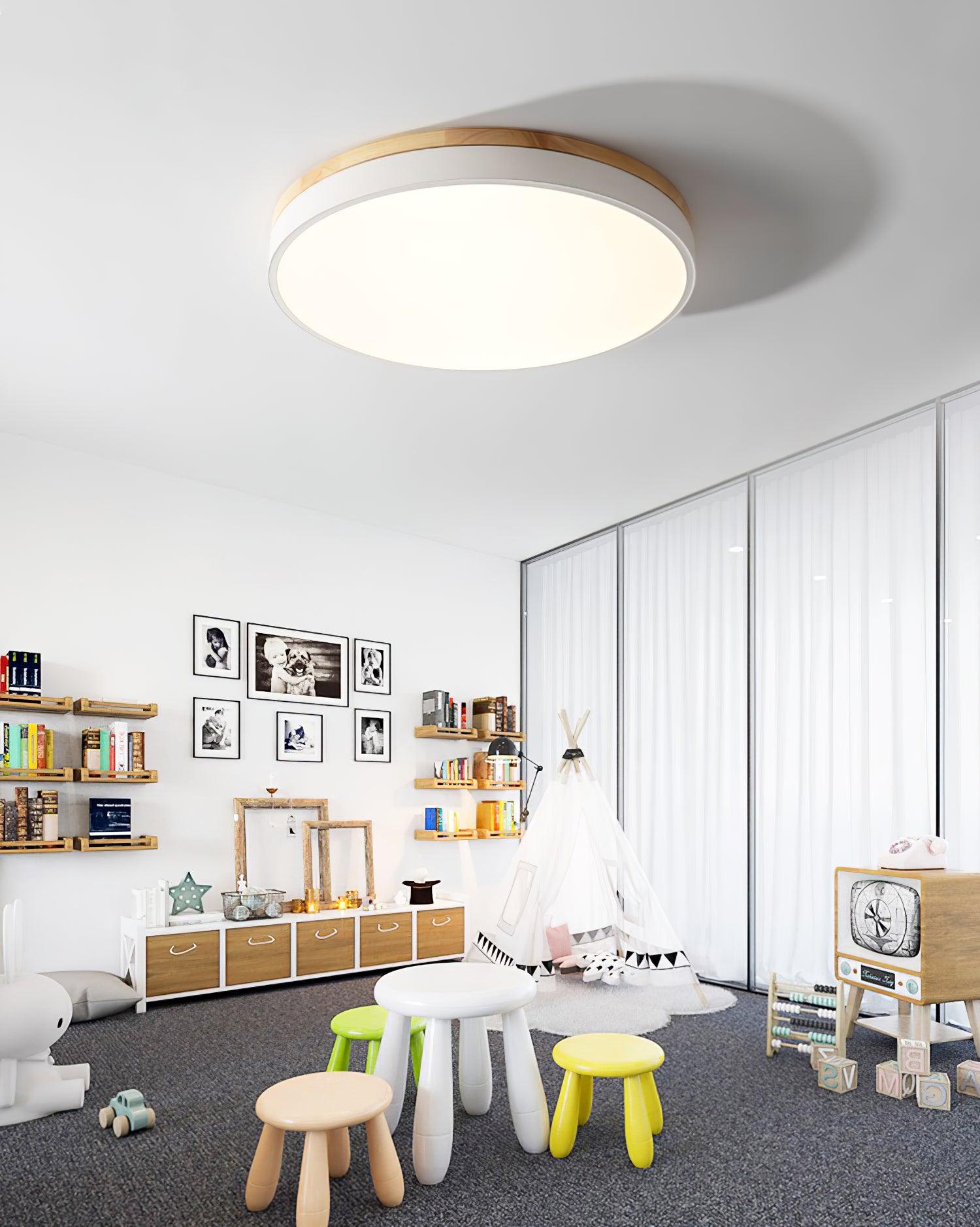 Round wooden ceiling light shown at an angle when lit