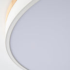 Round wood and white ceiling light lit warmly at home