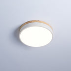 Round wood and white flush mount ceiling light glowing softly