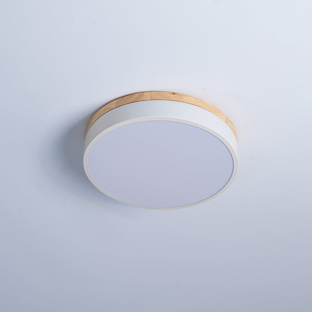 White ceiling light with warm wood rim seen from below