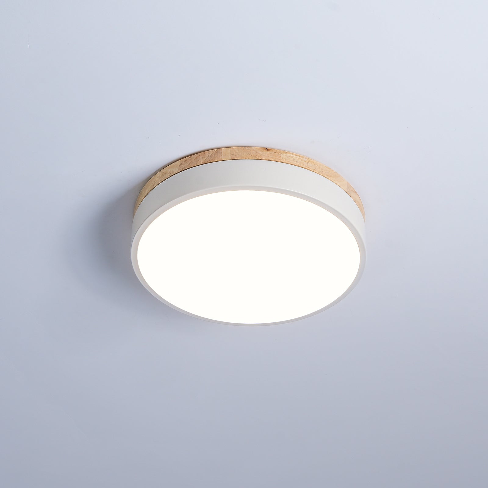 Round wooden ceiling light shown in a modern living room