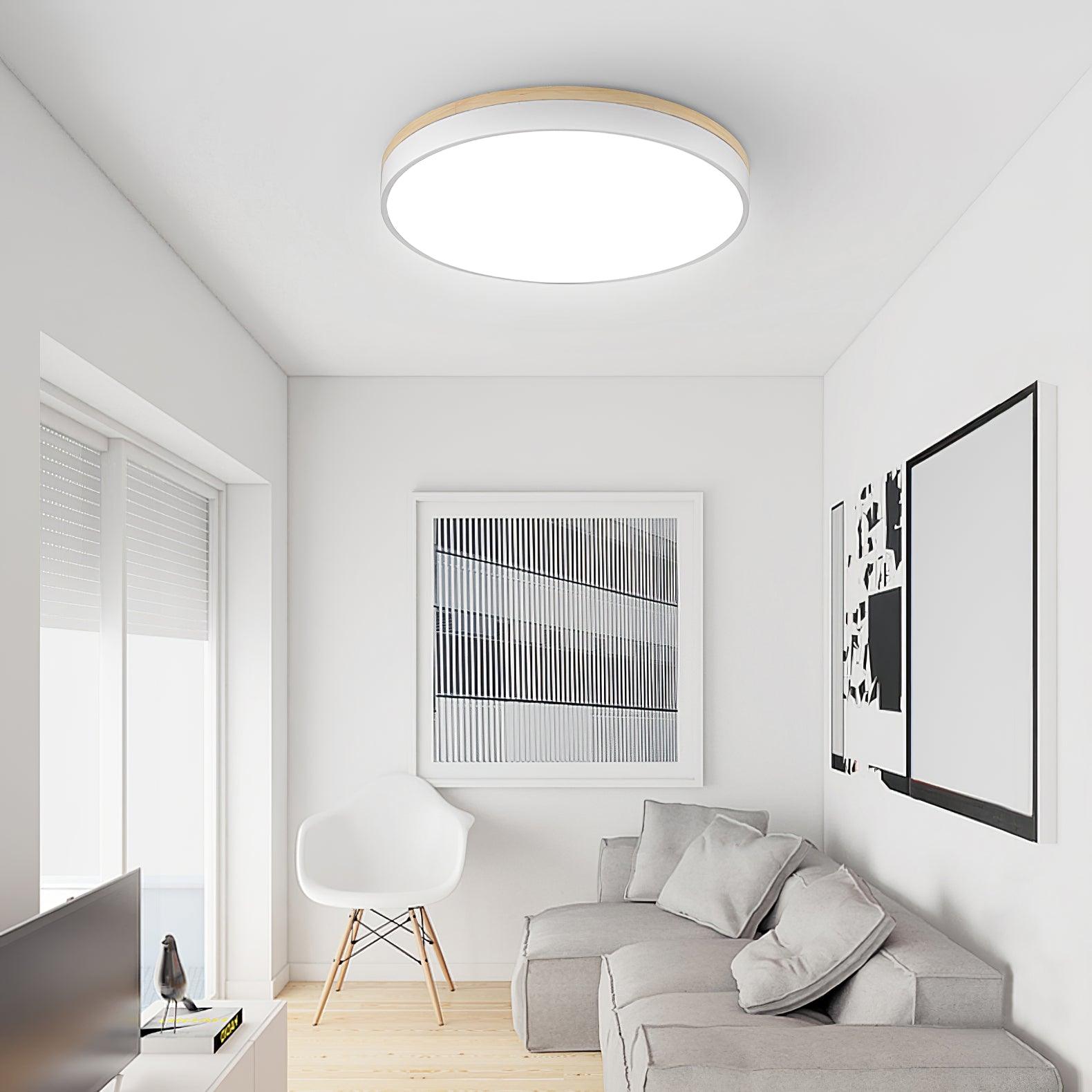 White ceiling light with wooden rim lit at night