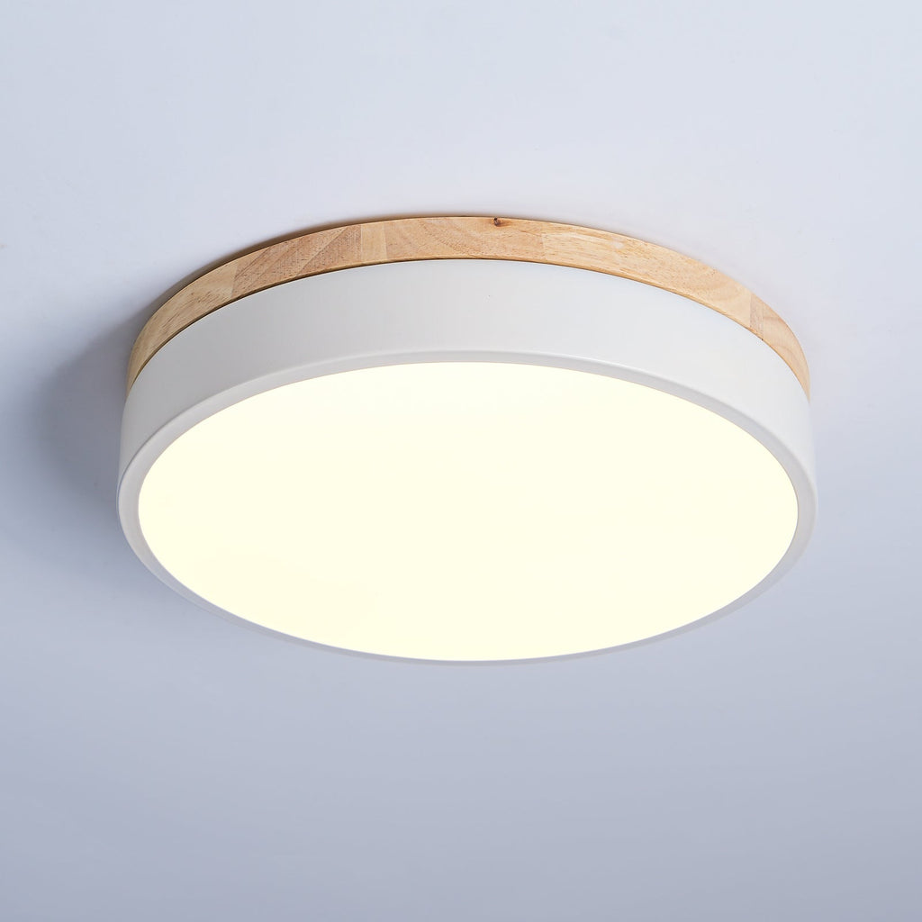 Flush mount ceiling light with warm glow above a sofa