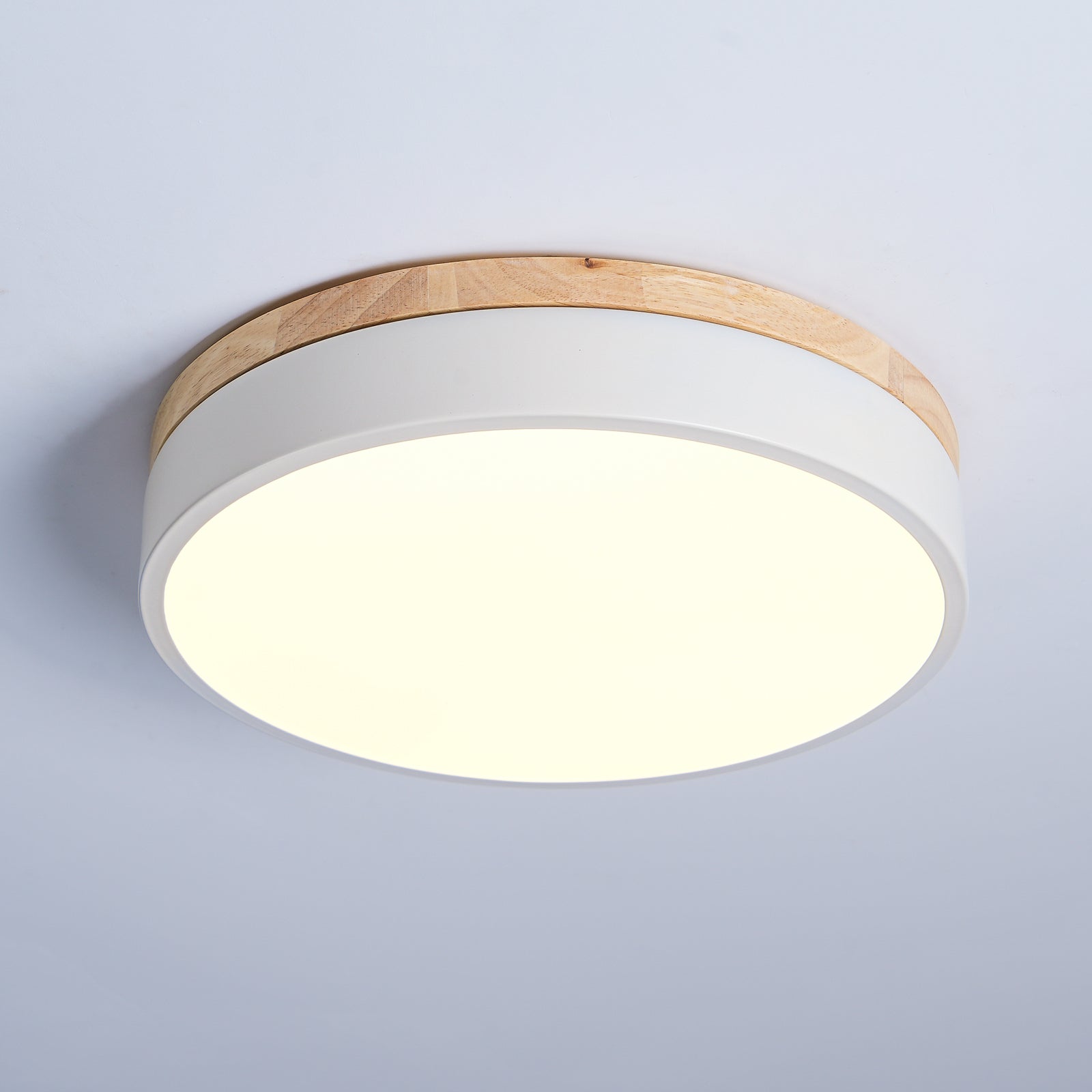 Flush mount ceiling light with warm glow above a sofa