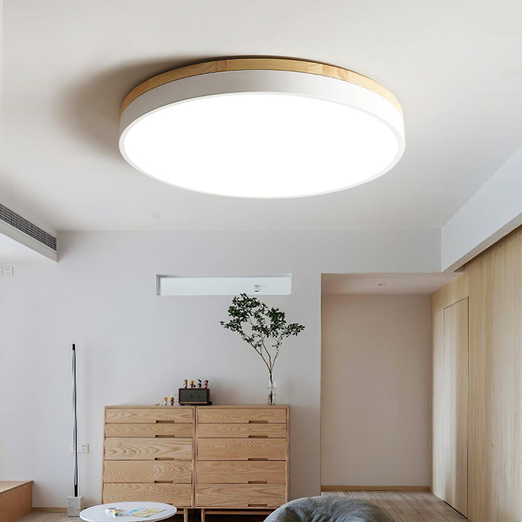 Round wood and white ceiling light in a styled interior