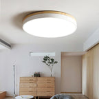 Round wood and white ceiling light in a styled interior