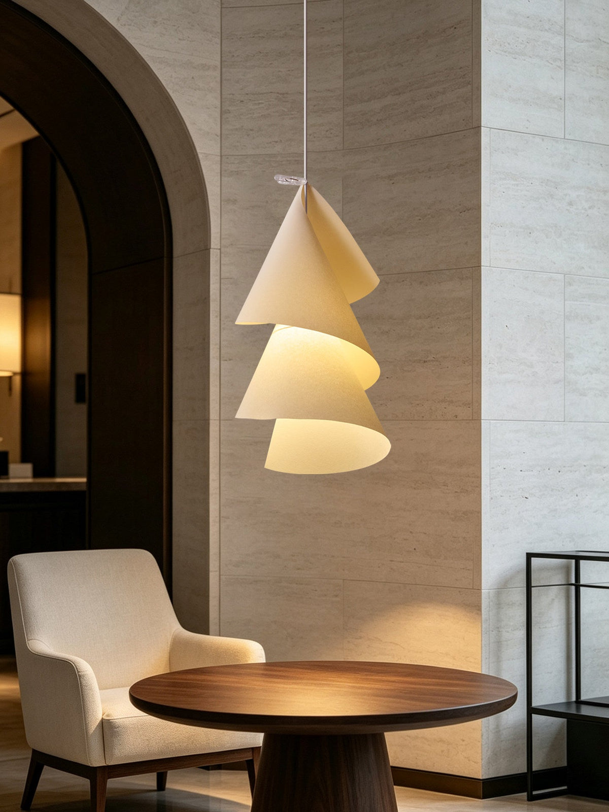 Beside an armchair and a round dark-wood table, this Clérachic pendant's cones spiral downward.
