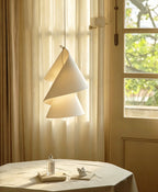 Near a curtained window, this Clérachic pendant's paper cones catch the afternoon light.