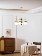 Classic chandelier with candle bulbs in a warm interior