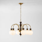 Walnut and gold chandelier full view glowing softly