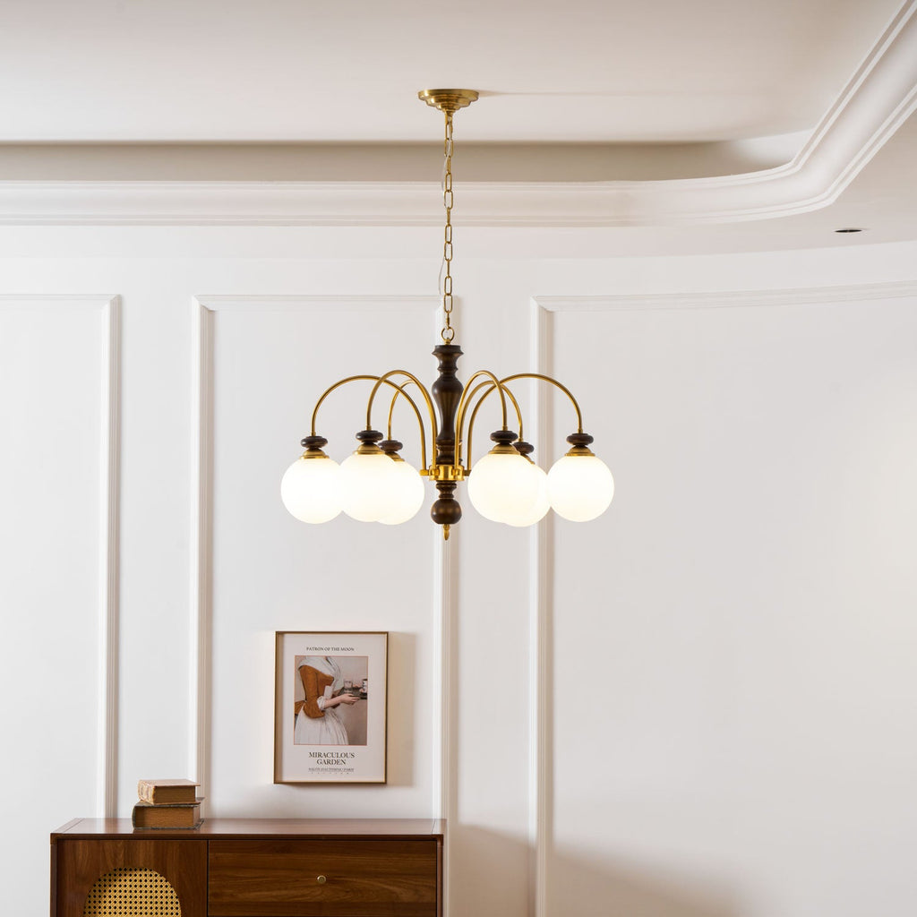 Classic chandelier shown from the side in walnut and gold