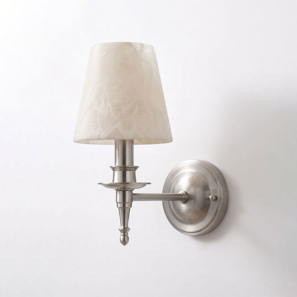 Unlit on a plain white background, this brushed nickel Clérachic wall sconce reveals its turned candlestick column.