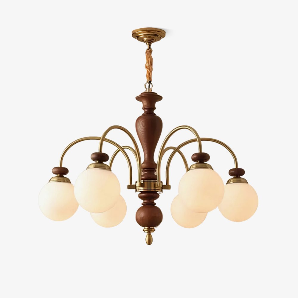 Walnut and gold chandelier shown against a pale wall