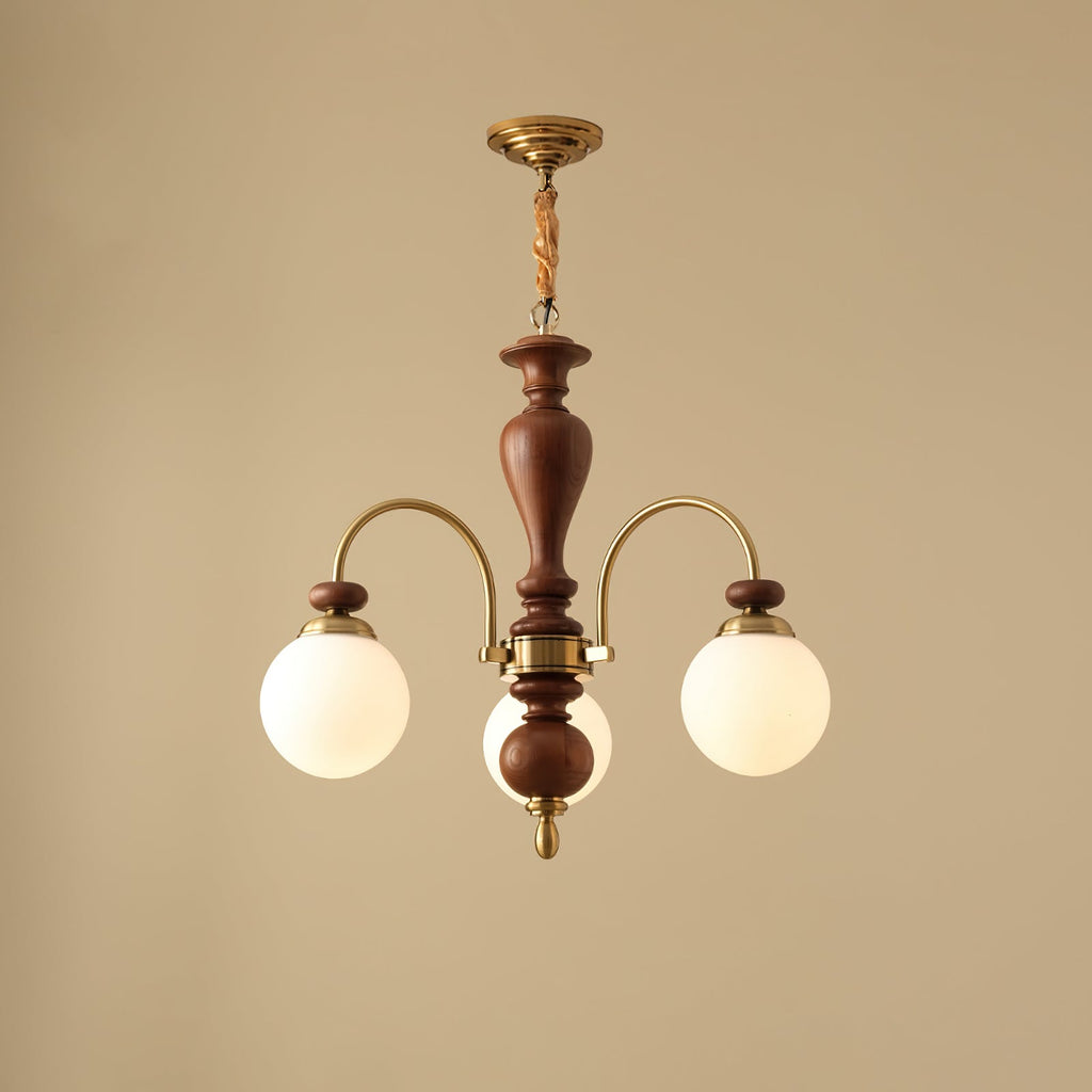 Walnut and gold chandelier with candle arms over a table