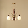 Walnut and gold chandelier with candle arms over a table
