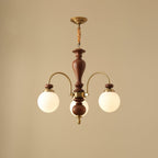 Walnut and gold chandelier with candle arms over a table