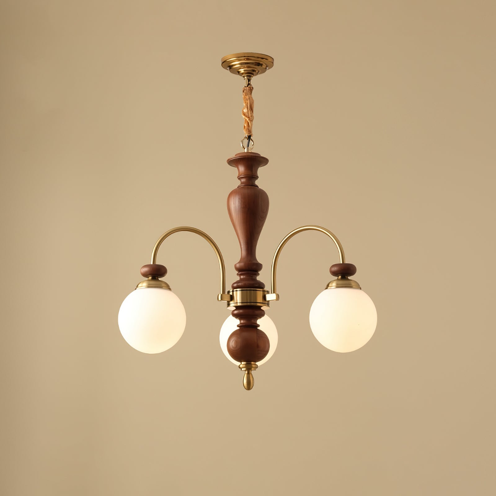 Walnut and gold chandelier with candle arms over a table