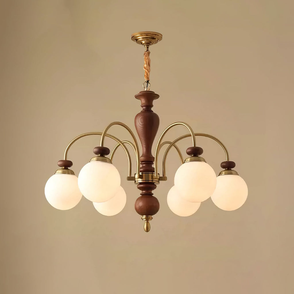 Black and nickel chandelier glowing in a dining room