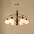 Black and nickel chandelier glowing in a dining room