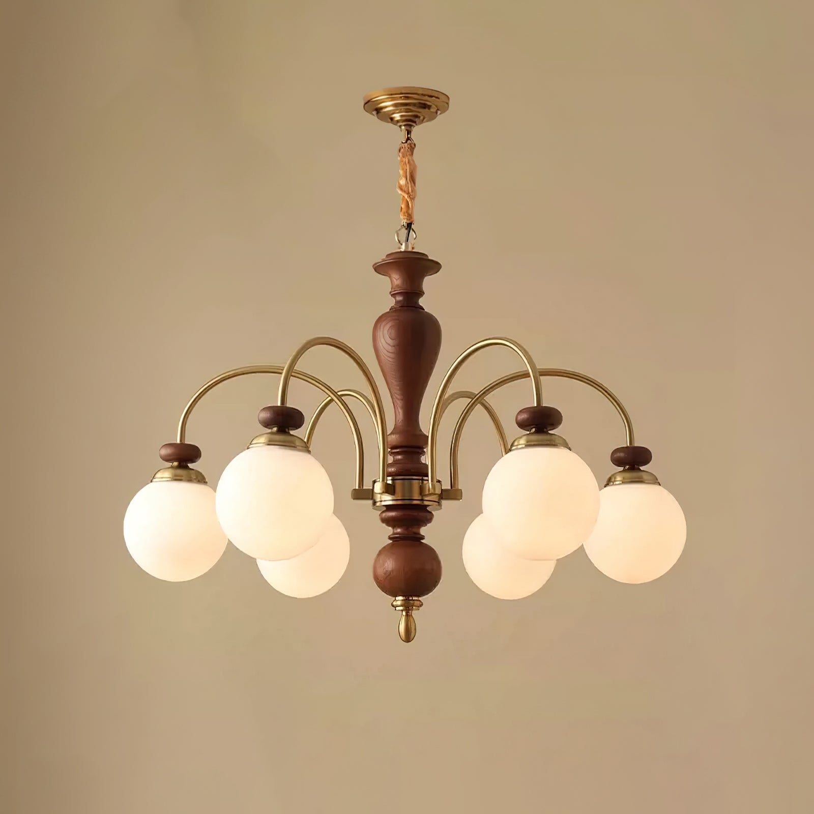 Black and nickel chandelier glowing in a dining room