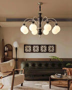 Walnut and gold chandelier hanging in a formal dining room