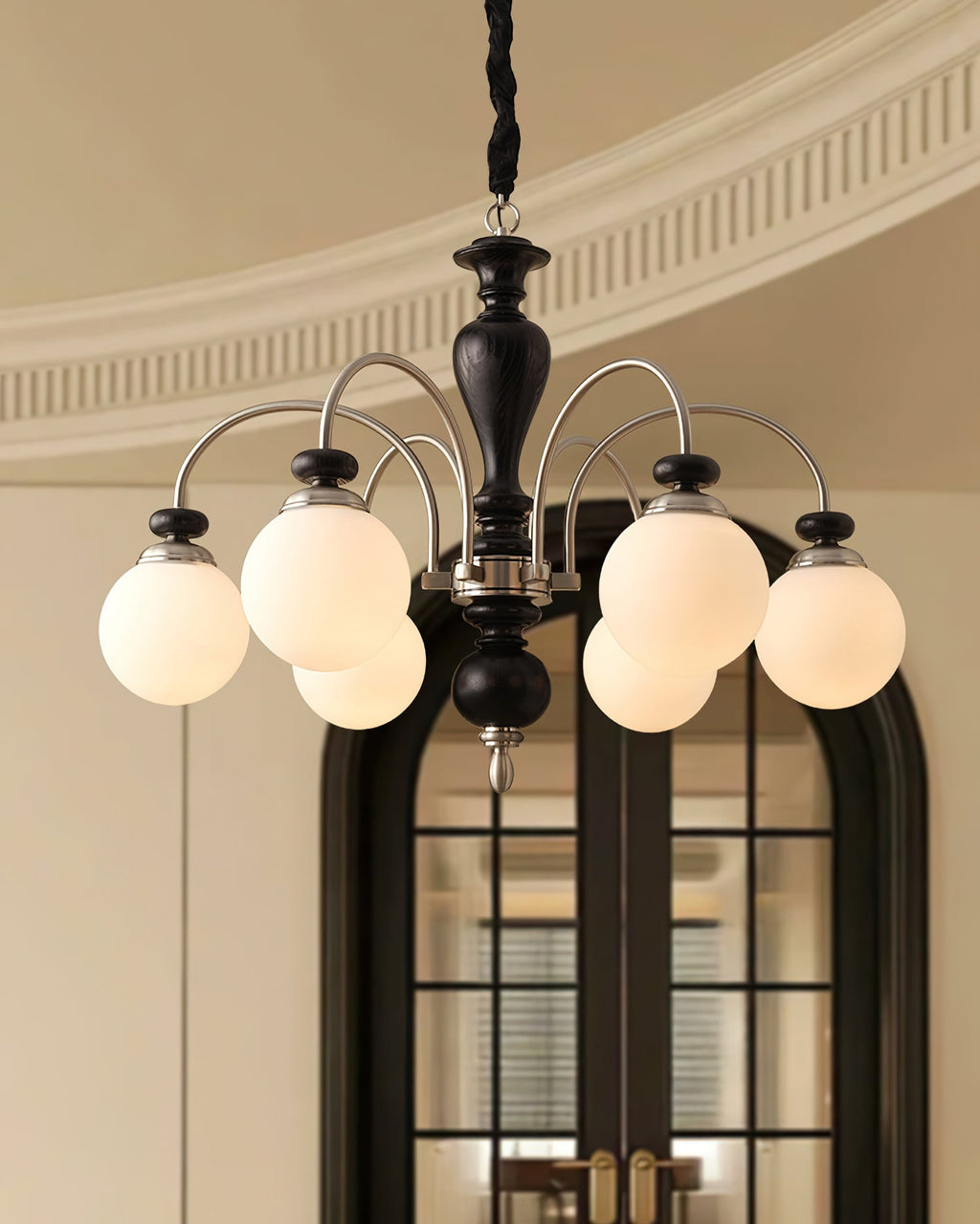 Black nickel chandelier shown lit in a bright room