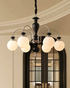 Black nickel chandelier shown lit in a bright room